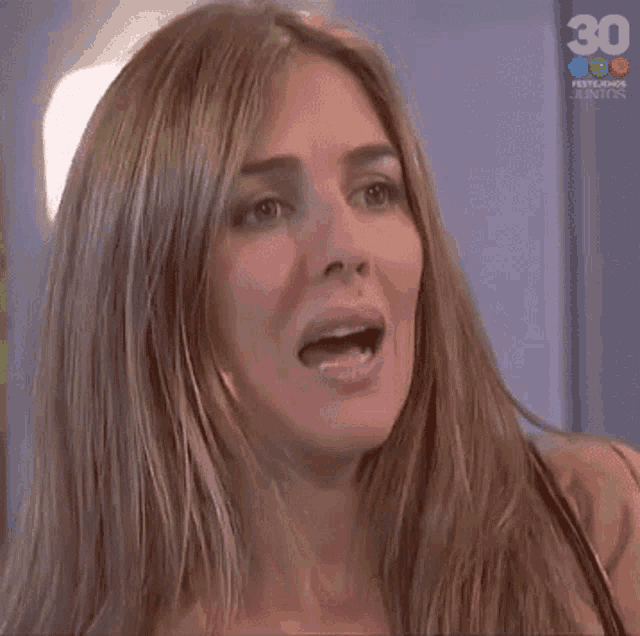 a close up of a woman 's face with the number 30 above her