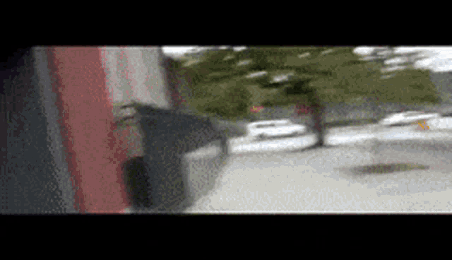 a blurry picture of a person standing on a sidewalk
