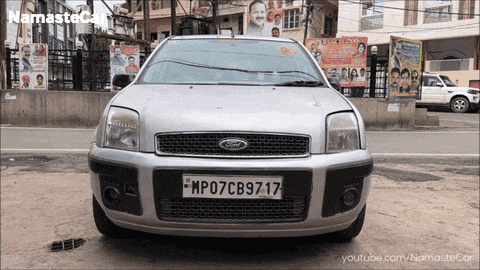 a silver ford car with a license plate that reads mp07cb9717