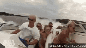 a group of people are riding a boat in the water .