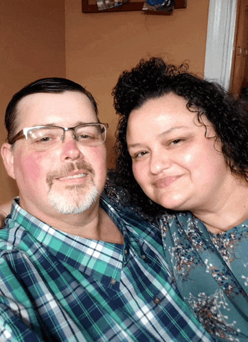 a man and a woman pose for a picture together