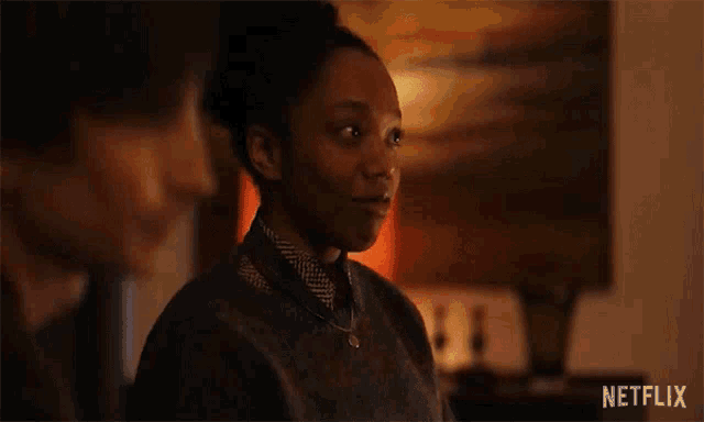 a woman is talking to a man in a living room in a netflix ad .