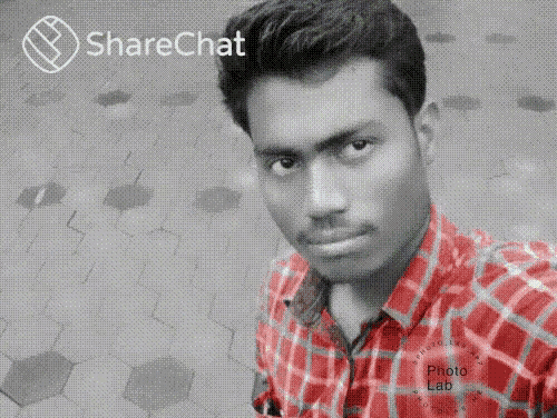 a man wearing a red plaid shirt is taking a selfie with the sharechat logo in the background