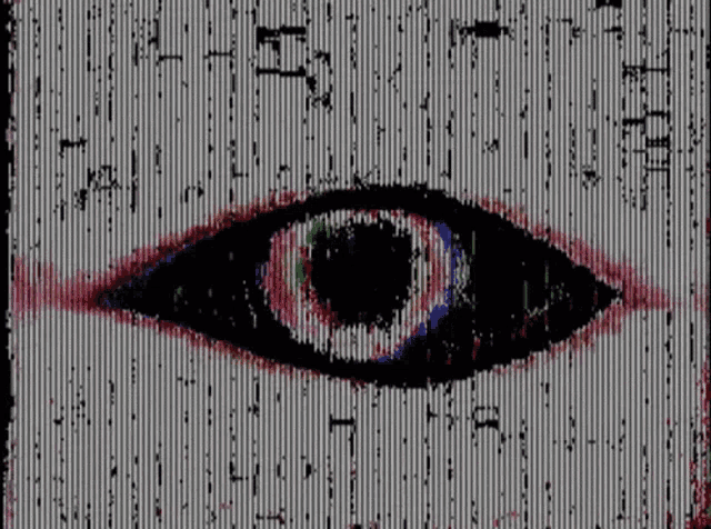 a close up of a person 's eye with a rainbow colored pupil