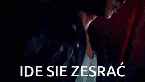 a man in a leather jacket is walking down a street with a sword and a sign that says ide sie zesrac .