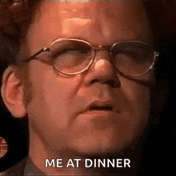 a man wearing glasses is making a face and says `` me at dinner '' .