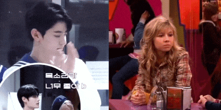 a boy and a girl are sitting at a table in a cafeteria
