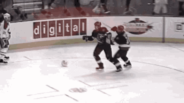 hockey players on the ice in front of a digital advertisement