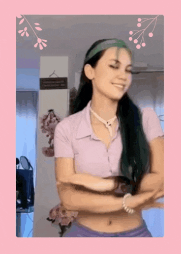 a woman wearing a purple shirt and purple shorts is dancing