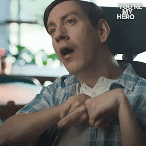 a man in a wheelchair with the words " you 're my hero " behind him