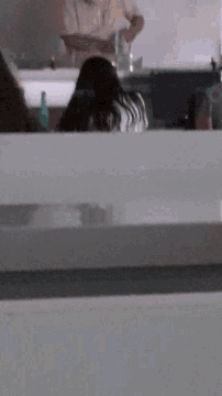 a blurred image of a person standing in a room