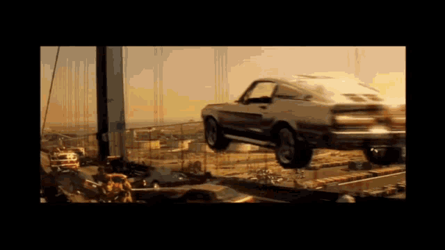 a car is being lifted by a crane in a movie scene