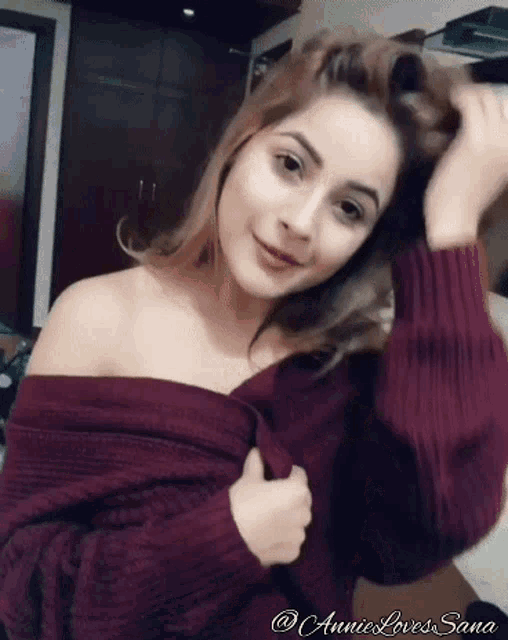 a woman wearing a maroon off the shoulder sweater with the words annie loves sana on the bottom