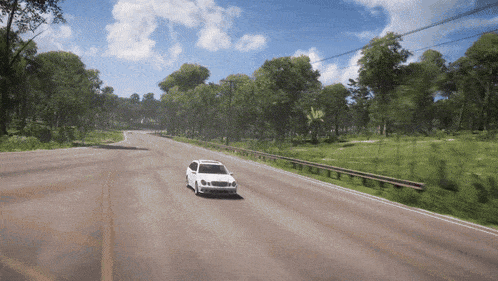 a white car is driving down a road in a video game