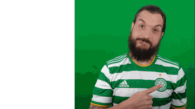 a man with a beard wearing a green and white adidas jersey