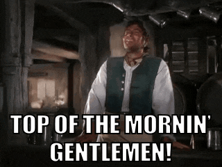 a man is standing in a room and saying `` top of the morning gentlemen '' .
