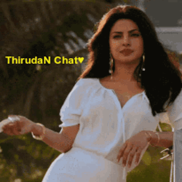 a woman in a white dress is standing in front of a sign that says thirudan chat