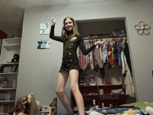 a girl is dancing in front of a closet with the name brielle on it
