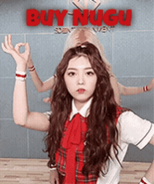 a girl in a red and white plaid shirt giving an ok sign