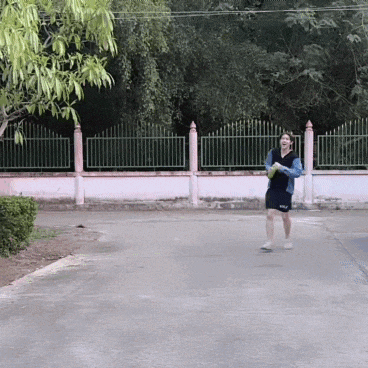 a man in a blue shirt and black shorts is running down the street