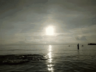 a man stands in the middle of a body of water