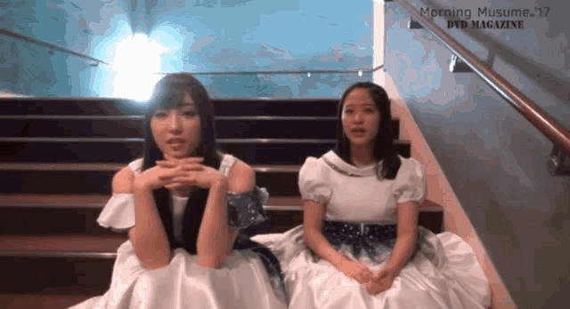 two girls are sitting on a set of stairs with the words morning musume '17 dvd magazine above them
