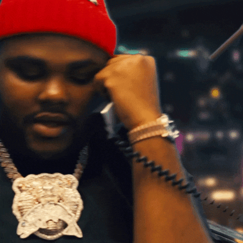 a man in a red hat is talking on a telephone