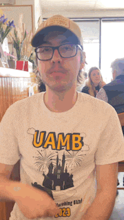 a man wearing a t-shirt that says uamb