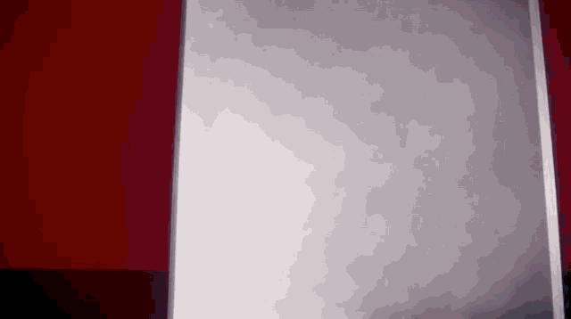 a red and white striped wall with a gray wall in the middle