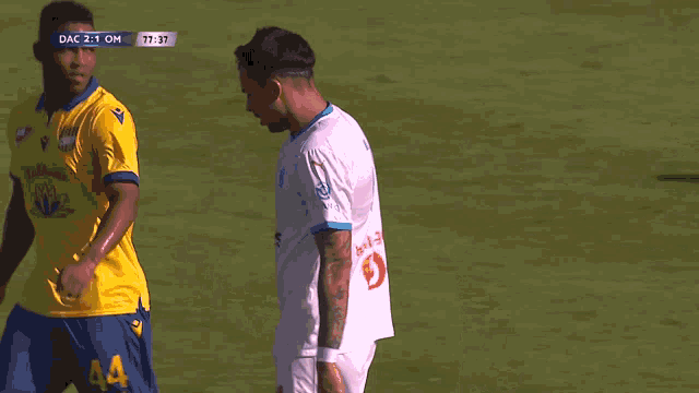 a soccer player wearing a number 7 jersey talks to another player