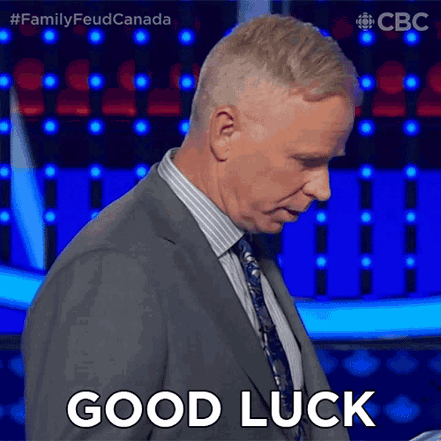 a man in a suit is saying good luck