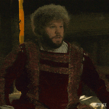 a man with curly hair and beard says that 's fantastic