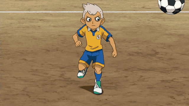a boy in a yellow and blue shirt with the letter s on it