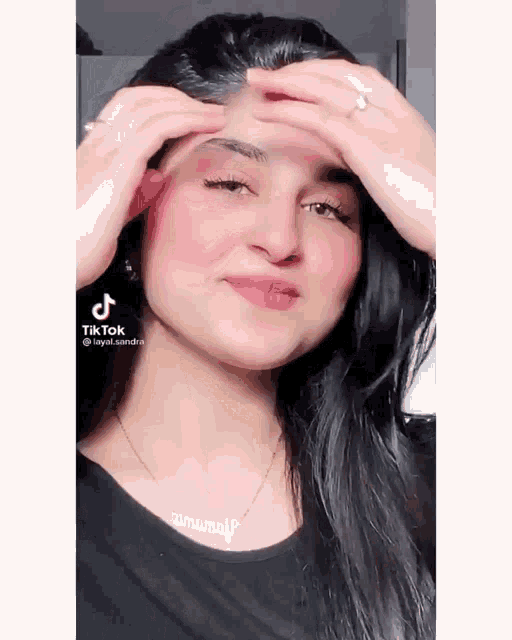 a woman 's face is shown in a tiktok video with a ring on her finger