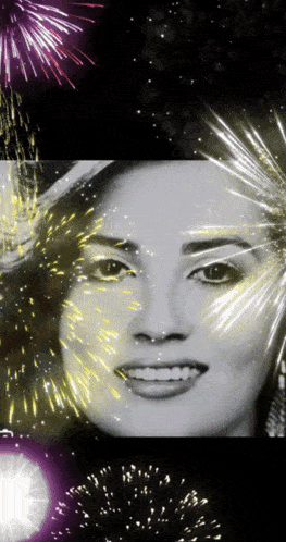 a black and white photo of a smiling woman with fireworks behind her