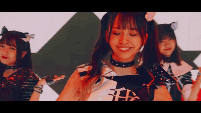 a girl with a choker around her neck has the letter h on it
