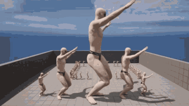 a group of men are dancing on a roof and one of them has the word calvin klein on his underwear