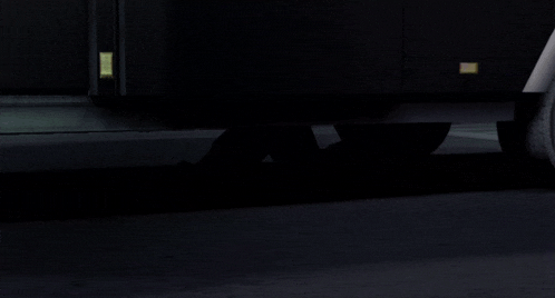 a person 's feet are visible in the dark in front of a door