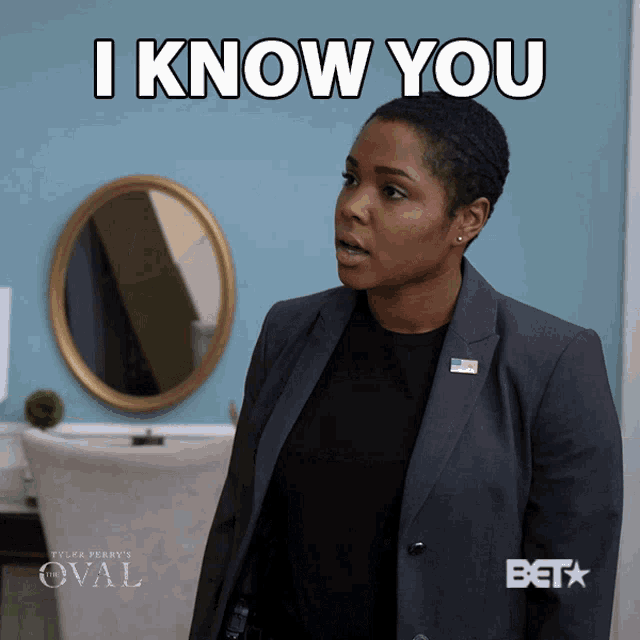 a woman in a suit says " i know you "