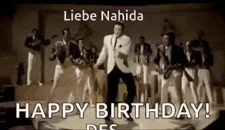 a man is dancing on a stage with a band behind him and the words `` happy birthday ! ''