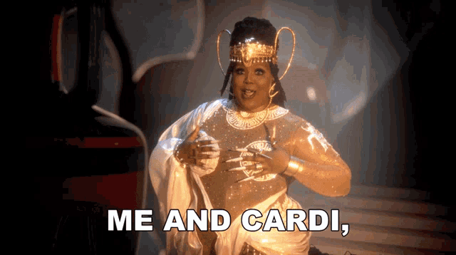 a woman in a costume with the words me and cardi behind her