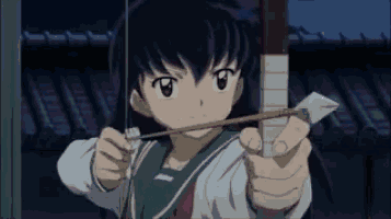 a young girl is holding a bow and arrow in her hand .