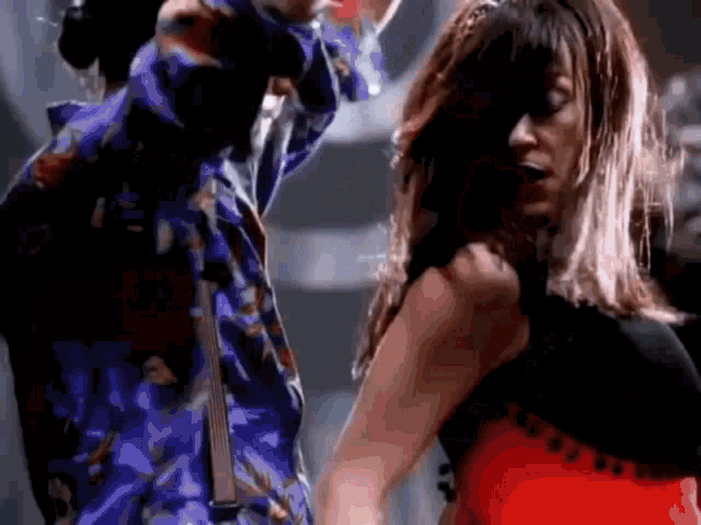 a man and a woman are dancing together in a dark room .