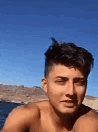 a shirtless young man is looking at the camera