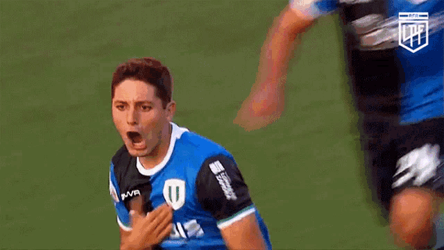 a soccer player in a blue jersey with the letter u on the front