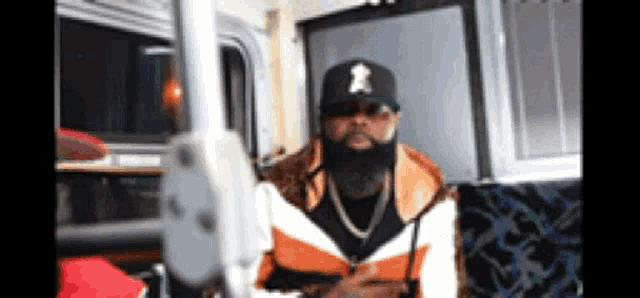 a man with a beard wearing a hat with the letter a on it