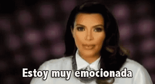 kim kardashian is wearing a white shirt and tie and is talking in spanish .