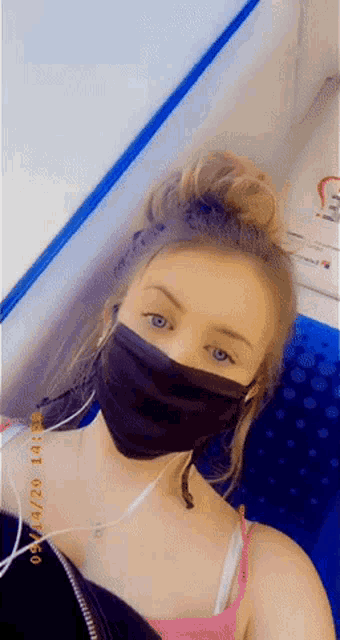 a woman wearing a face mask has a photo taken on 09/28/21