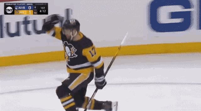 a hockey player wearing number 17 is kneeling on the ice
