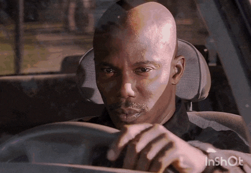 a man is driving a car with the watermark inshot on the bottom right